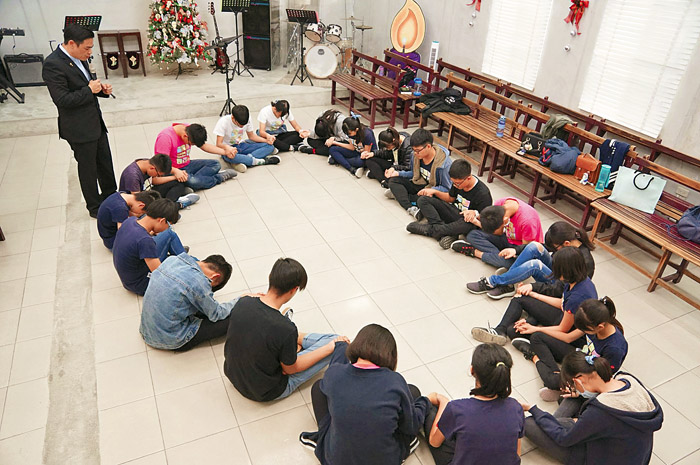 莊信仁牧師為青少年祝福禱告。