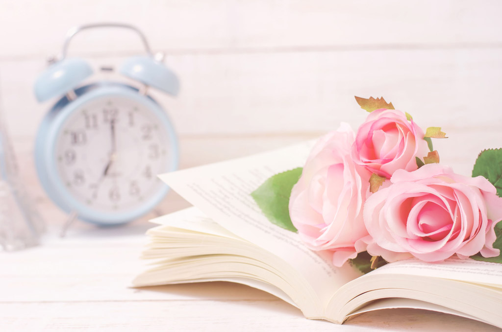 Pastel artificial rose and open book with vintage tone