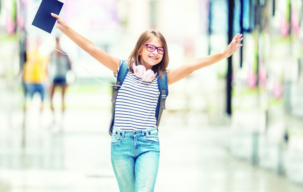 Schoolgirl with bag, backpack. Portrait of modern happy teen sch
