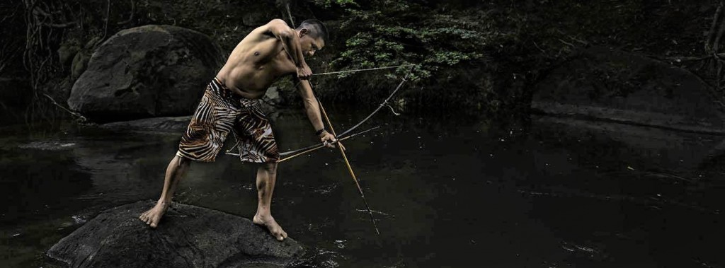 年輕的原住民在溪中捕魚。（圖／糧農組織，Brent Stirton攝）